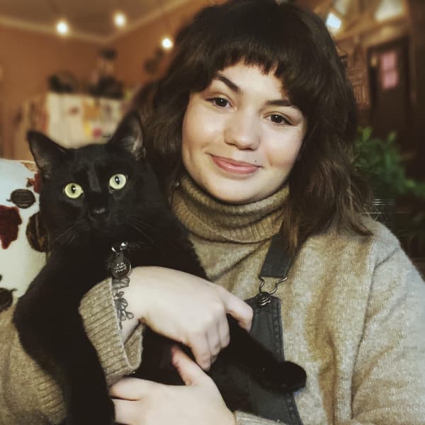 Watertown cat sitter holding black cat